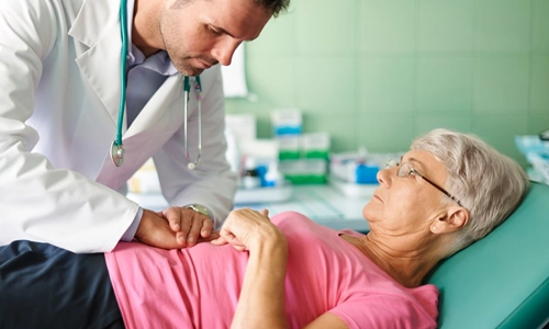 A mature woman consulting a doctor about preventive screenings like colonoscopies and bone density scans