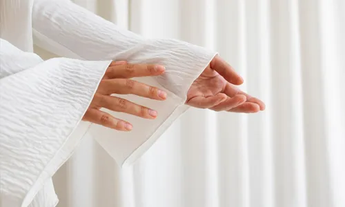 Portrait of a woman with smooth skin and a soft fabric backdrop