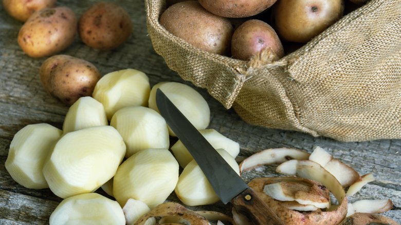 peeled and unpeeled potatoes in a jute bag and with a bag