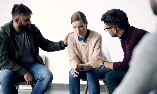 Two people sitting together during a supportive conversation