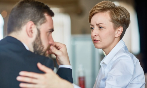 Woman comforting an upset man during an emotional conversation
