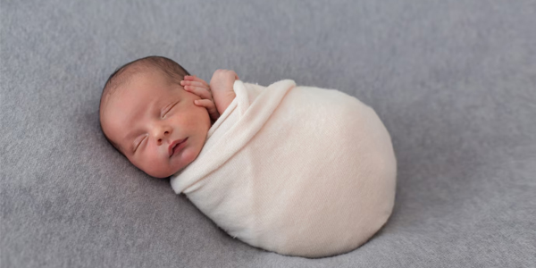 newborn-baby-wrapped-with-soft-pink-tissue