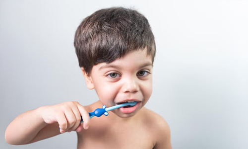 A kid brushing his teeth