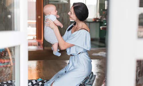 Woman-playing-with-her-baby-at-home