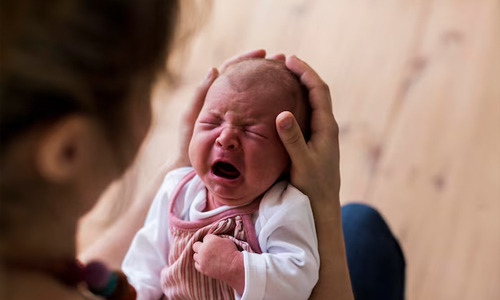 A-mother-holding-a-crying-baby