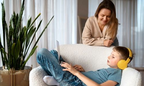 Mother talking to child about internet safety and cyberbullying