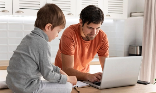 Parent helping a child use digital devices safely at home