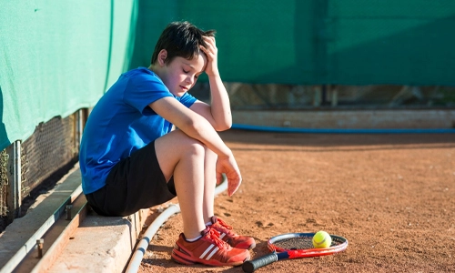 Child sitting and resting after a sports match