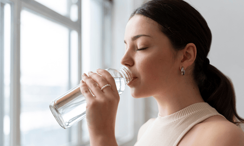women drinking water after workout