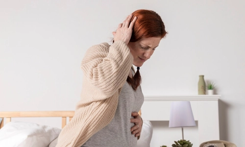 Side view of a pregnant woman with a headache seeking safe pain relief options.