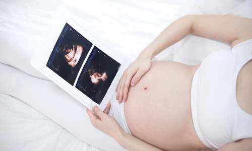 Young pregnant woman showing togetherness and care during the final stages of the third trimester.
