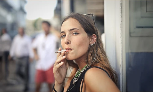 Portrait of a woman smoking outdoors