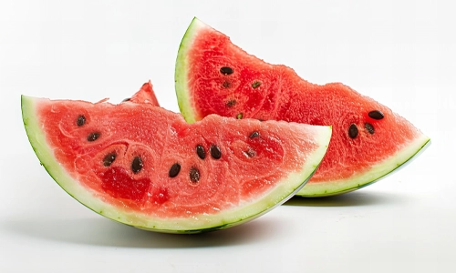 Close-up view of watermelon pieces with seeds in white background